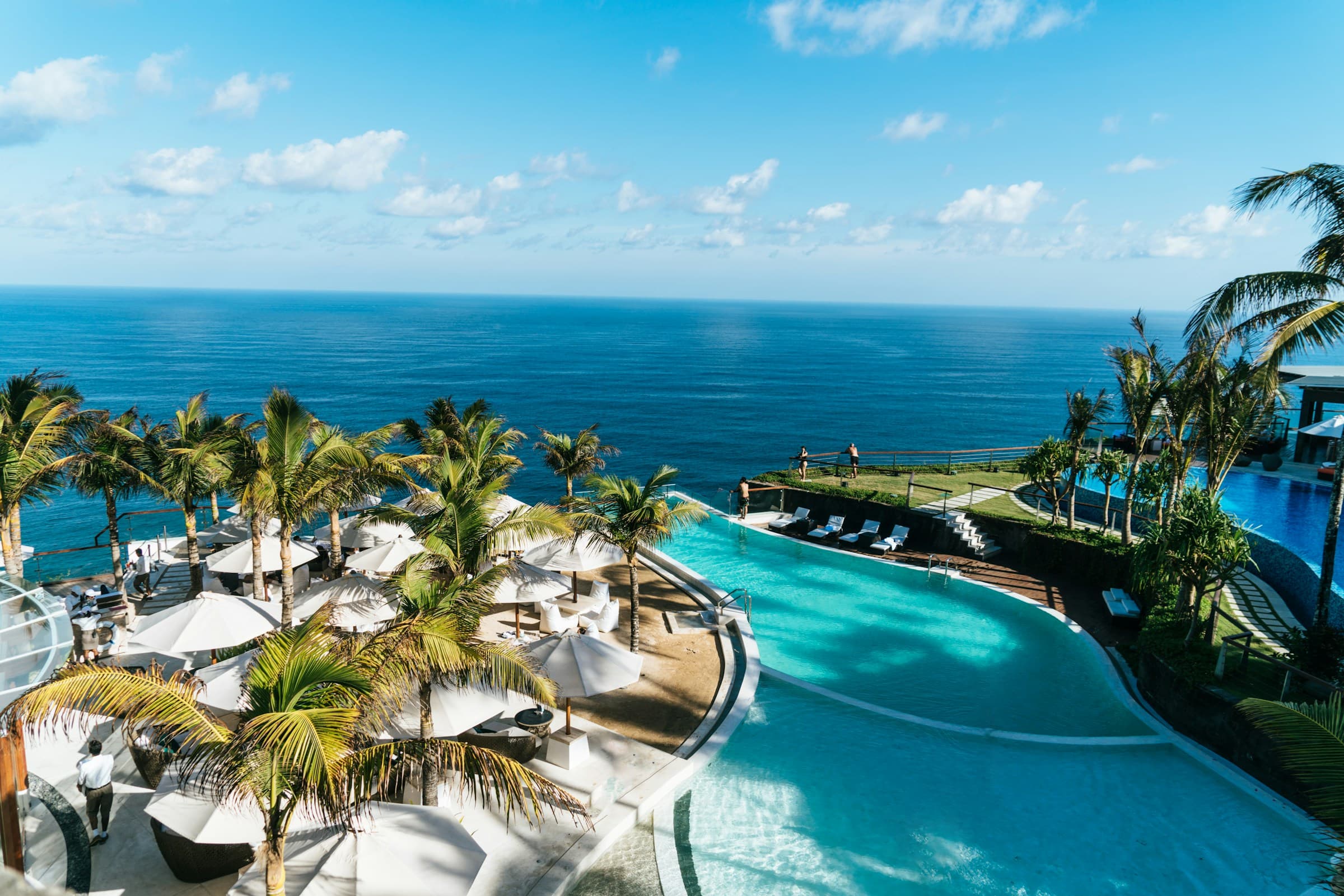 Oceanfront resort and infinity pool above a tropical coast