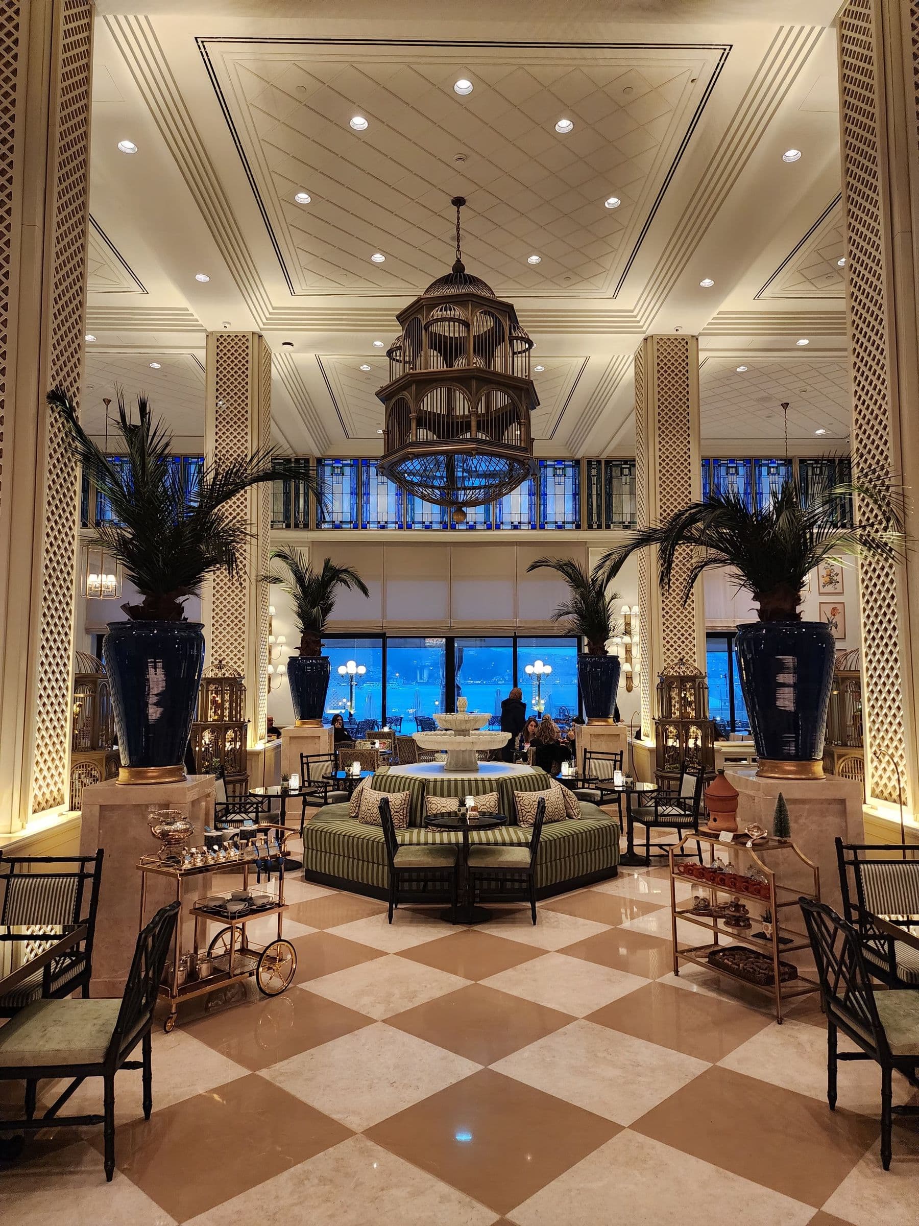 Grand marble hotel foyer with chandelier and discreet lounge seating