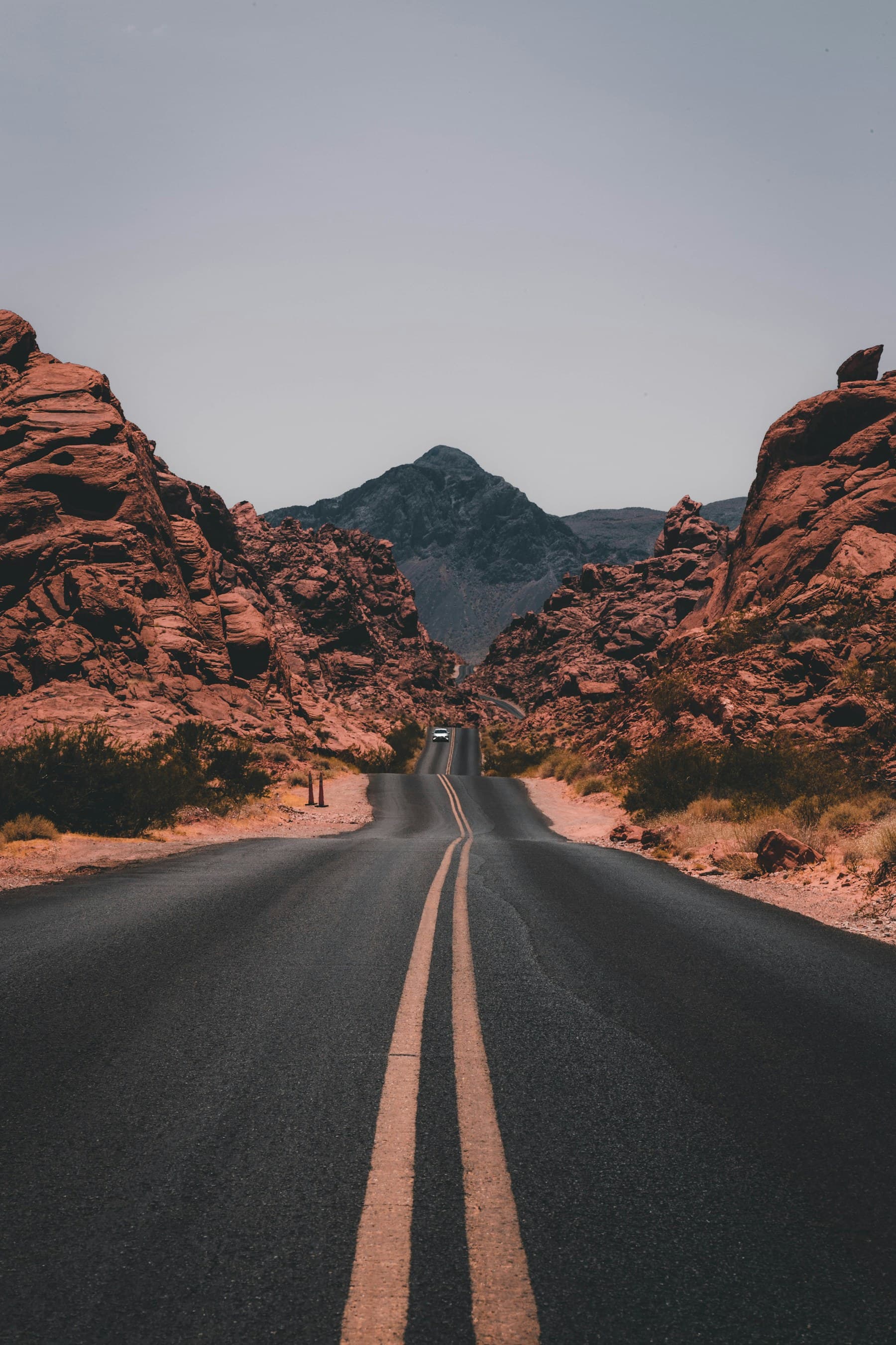 A quiet road through a dramatic desert landscape